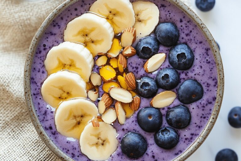Blueberry Smoothie Topped with Banana Slices and Slivered Almonds Recipe